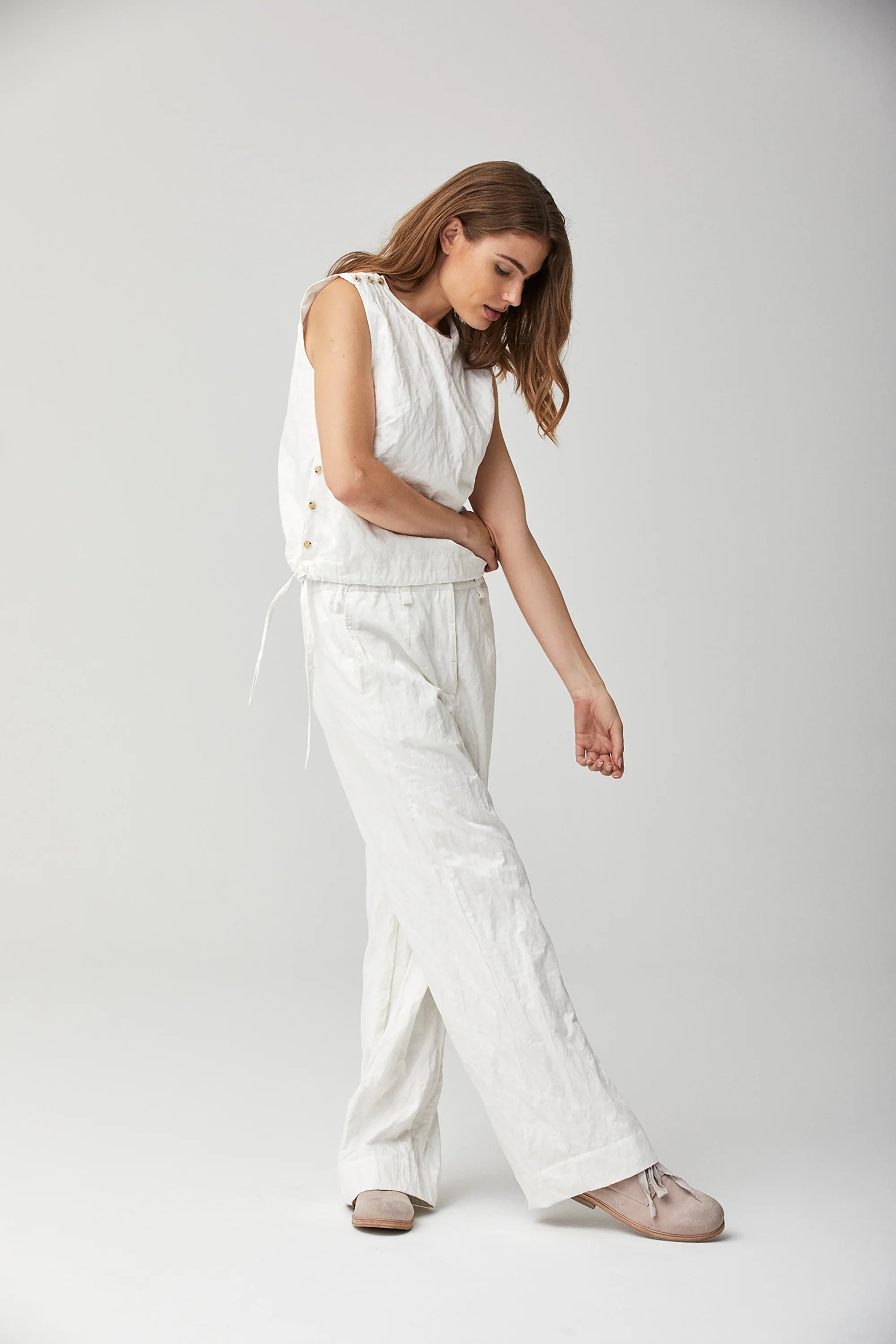TOAST - CRINKLE COTTON JUMPSUIT  Soft, crinkled cotton double cloth with  high round neckline. Button opening at back and low drawstring waist - can  be worn low or tied. Ankle-skimming and